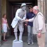stillman getting a comically painful handshake from an older man